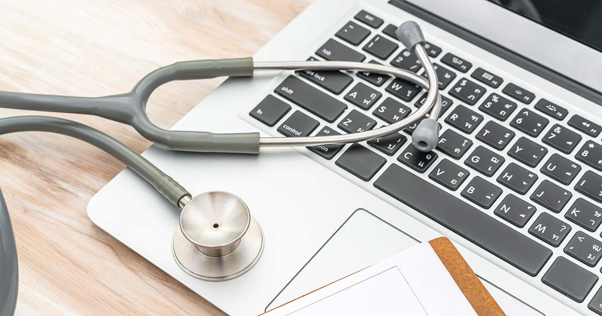 stethoscope on a laptop while doing nursing online education